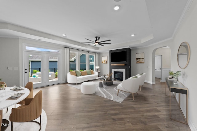 1319 Richfield Oaks Dr, Fuquay Varina, NC 27526 - living room with wood finished floors, a premium fireplace, a ceiling fan, arched walkways, and recessed lighting