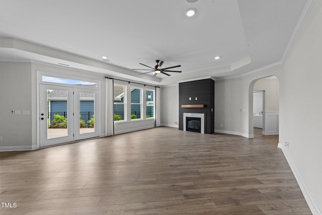 1319 Richfield Oaks Dr, Fuquay Varina, NC 27526 - unfurnished living room featuring ceiling fan, wood finished floors, a large fireplace, recessed lighting, and arched walkways