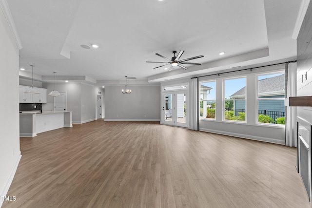 1319 Richfield Oaks Dr, Fuquay Varina, NC 27526 - unfurnished living room with a glass covered fireplace, ceiling fan, light wood-style flooring, recessed lighting, and a chandelier