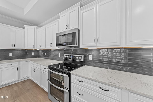 1319 Richfield Oaks Dr, Fuquay Varina, NC 27526 - kitchen featuring appliances with stainless steel finishes, white cabinetry, backsplash, light stone counters, and crown molding