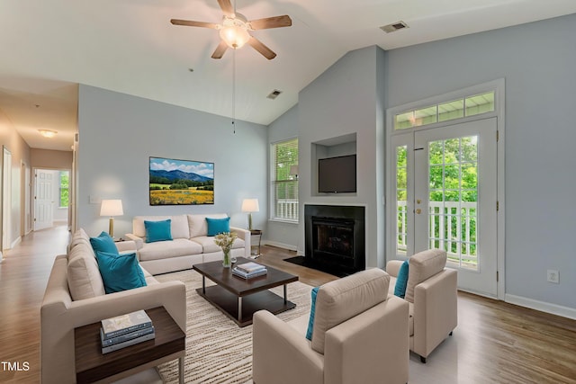 3010 Winston Dr Unit 81, Burlington, NC 27215 - living room with light wood-style flooring, a ceiling fan, a fireplace with flush hearth, and high vaulted ceiling