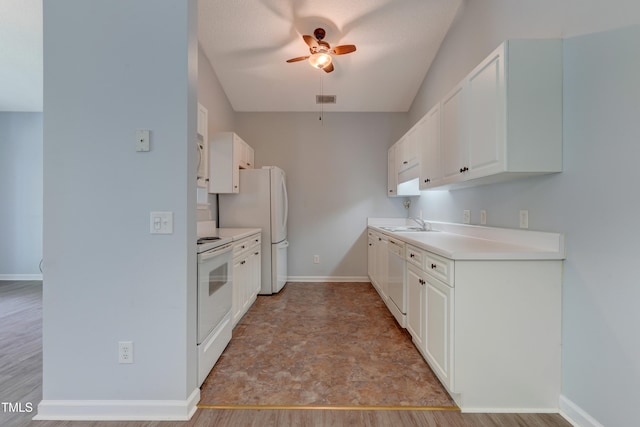3010 Winston Dr Unit 81, Burlington, NC 27215 - kitchen with white appliances, ceiling fan, white cabinets, light countertops, and light wood-style floors