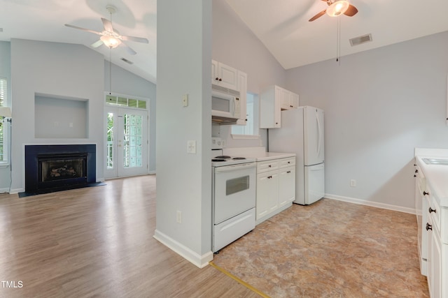 3010 Winston Dr Unit 81, Burlington, NC 27215 - kitchen featuring white appliances, a ceiling fan, white cabinets, light countertops, and a fireplace with flush hearth