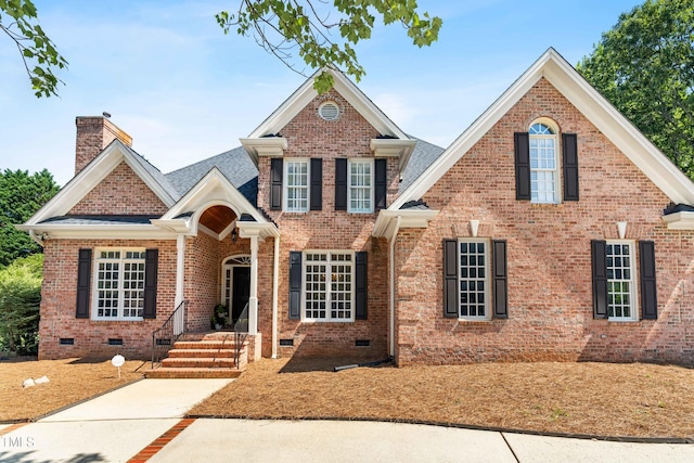 619 Baybush Dr, Raleigh, NC 27615 - view of front of home with crawl space, a chimney, brick siding, and roof with shingles