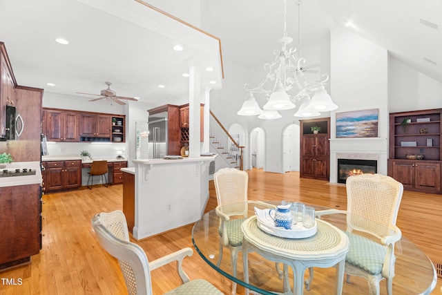 619 Baybush Dr, Raleigh, NC 27615 - dining area with ceiling fan, light wood finished floors, arched walkways, recessed lighting, and a fireplace with flush hearth