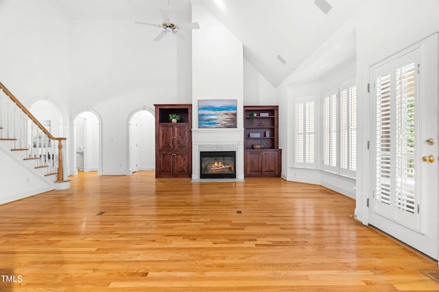 619 Baybush Dr, Raleigh, NC 27615 - unfurnished living room with high vaulted ceiling, plenty of natural light, light wood-style floors, and a high end fireplace