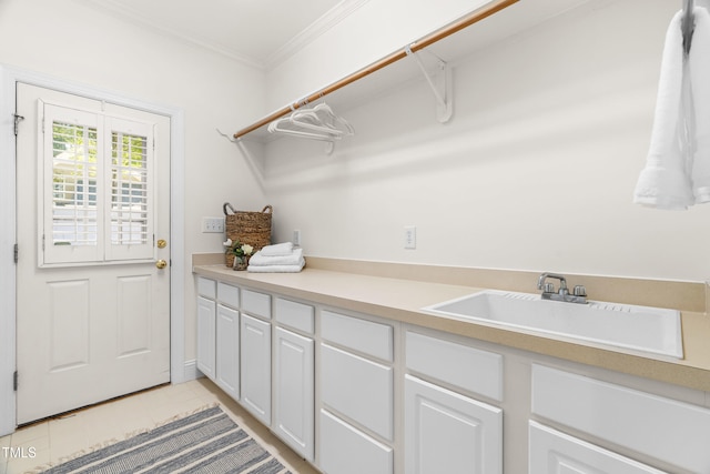 619 Baybush Dr, Raleigh, NC 27615 - laundry area with ornamental molding and light tile patterned floors
