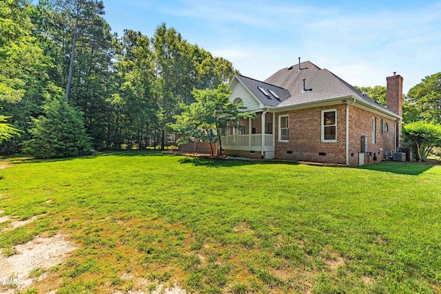 619 Baybush Dr, Raleigh, NC 27615 - rear view of house with crawl space, brick siding, a chimney, a lawn, and a sunroom