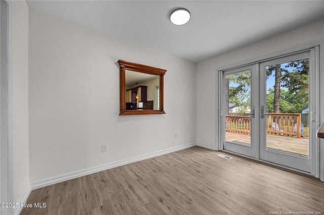240 Eppingdale Dr, Spring Lake, NC 28390 - unfurnished room with wood finished floors, baseboards, and french doors
