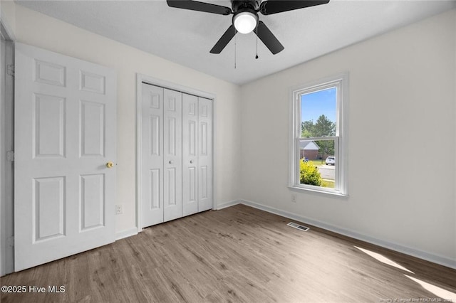 240 Eppingdale Dr, Spring Lake, NC 28390 - unfurnished bedroom featuring wood finished floors, baseboards, a closet, and ceiling fan