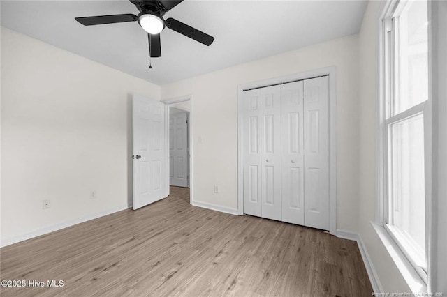 240 Eppingdale Dr, Spring Lake, NC 28390 - unfurnished bedroom with light wood finished floors, baseboards, a closet, and ceiling fan