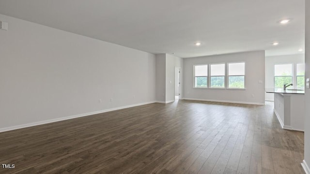 190 Babbling Creek Dr, Youngsville, NC 27596 - empty room with healthy amount of natural light, dark wood finished floors, baseboards, and recessed lighting