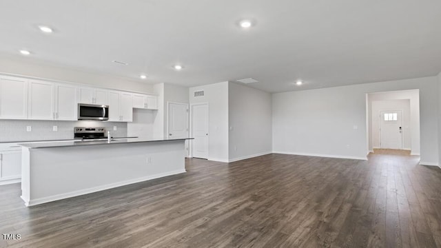 190 Babbling Creek Dr, Youngsville, NC 27596 - kitchen featuring stainless steel appliances, a center island with sink, white cabinetry, dark wood finished floors, and recessed lighting