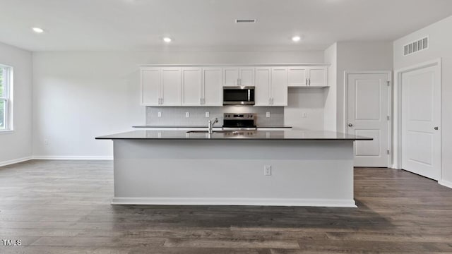 190 Babbling Creek Dr, Youngsville, NC 27596 - kitchen featuring stainless steel microwave, range, white cabinets, a sink, and backsplash