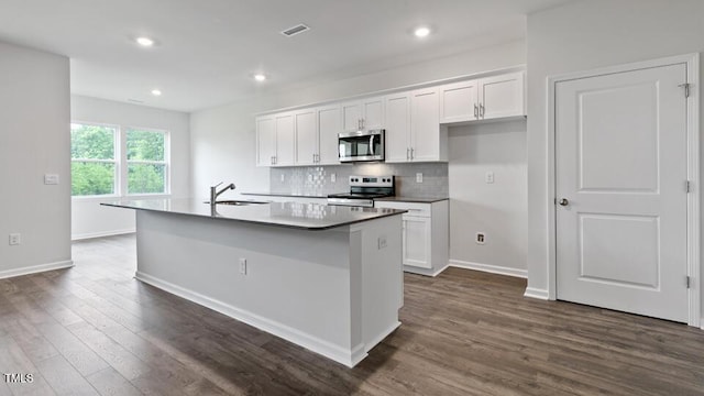 190 Babbling Creek Dr, Youngsville, NC 27596 - kitchen with stainless steel appliances, a sink, white cabinets, baseboards, and recessed lighting