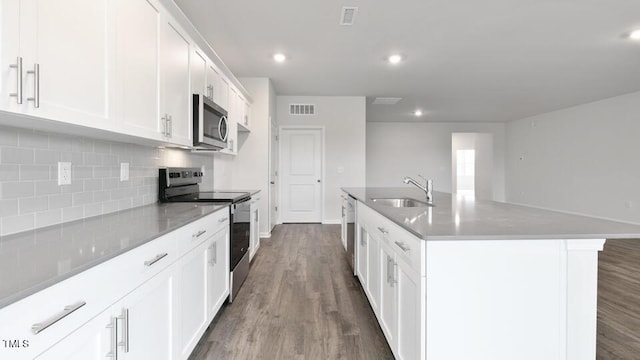 190 Babbling Creek Dr, Youngsville, NC 27596 - kitchen featuring appliances with stainless steel finishes, decorative backsplash, a sink, dark wood-type flooring, and white cabinets