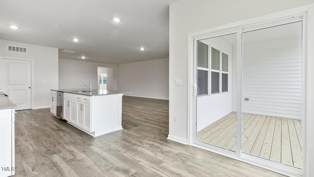 190 Babbling Creek Dr, Youngsville, NC 27596 - kitchen with light wood-style floors, white cabinets, an island with sink, recessed lighting, and open floor plan