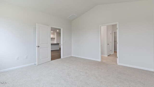 190 Babbling Creek Dr, Youngsville, NC 27596 - unfurnished bedroom featuring light colored carpet, vaulted ceiling, and baseboards