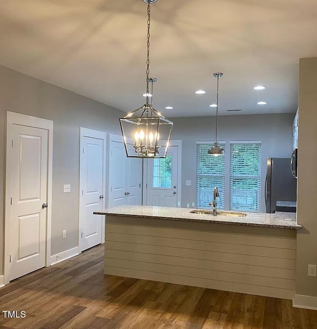 18 Danbury Ct, Pittsboro, NC 27312 - kitchen with freestanding refrigerator, a sink, dark wood-type flooring, light stone counters, and baseboards