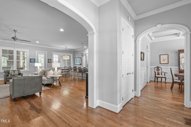 2121 Vecchio Ln, Apex, NC 27502 - entrance foyer with arched walkways, crown molding, a ceiling fan, wood finished floors, and recessed lighting