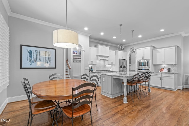 2121 Vecchio Ln, Apex, NC 27502 - dining area featuring recessed lighting, ornamental molding, stairs, and light wood-style floors