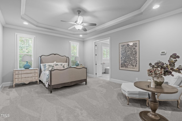 2121 Vecchio Ln, Apex, NC 27502 - carpeted bedroom featuring a tray ceiling, ornamental molding, recessed lighting, ceiling fan, and ensuite bath