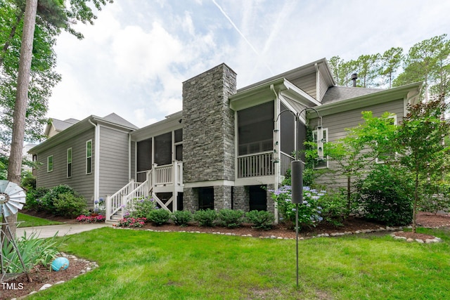 2121 Vecchio Ln, Apex, NC 27502 - rear view of house with a sunroom, stairs, a lawn, and a chimney