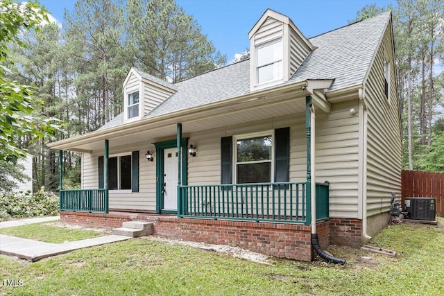 4709 Tyne Dr, Durham, NC 27703 - cape cod house featuring covered porch, a front lawn, and roof with shingles