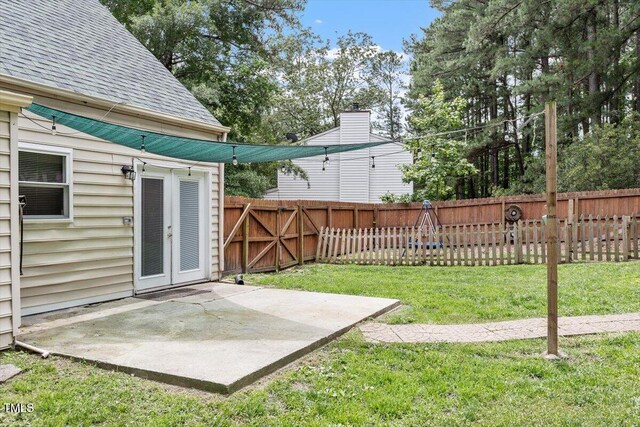 4709 Tyne Dr, Durham, NC 27703 - fenced backyard featuring a patio area and french doors