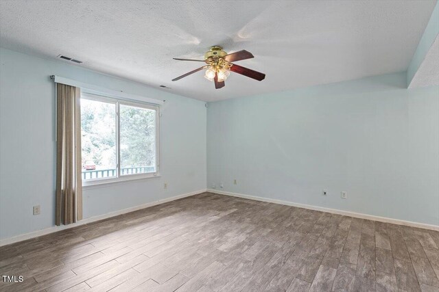 4709 Tyne Dr, Durham, NC 27703 - unfurnished room with wood finished floors, ceiling fan, and a textured ceiling