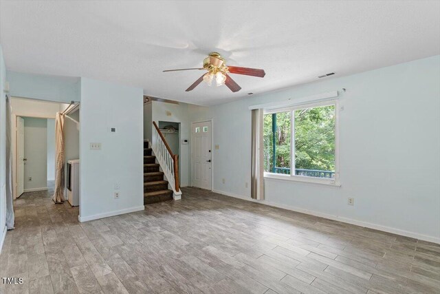 4709 Tyne Dr, Durham, NC 27703 - unfurnished living room with ceiling fan, light wood finished floors, and stairs