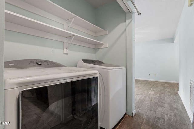 4709 Tyne Dr, Durham, NC 27703 - laundry room featuring washer and dryer and wood finished floors
