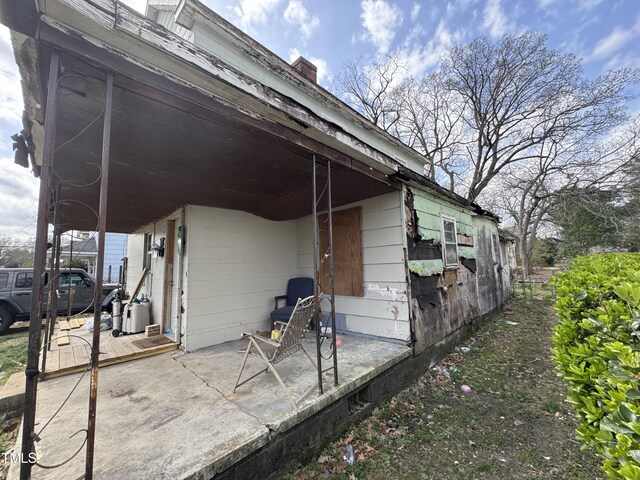 921 Franklin St, Roanoke Rapids, NC 27870 - view of property exterior featuring a patio area and a chimney