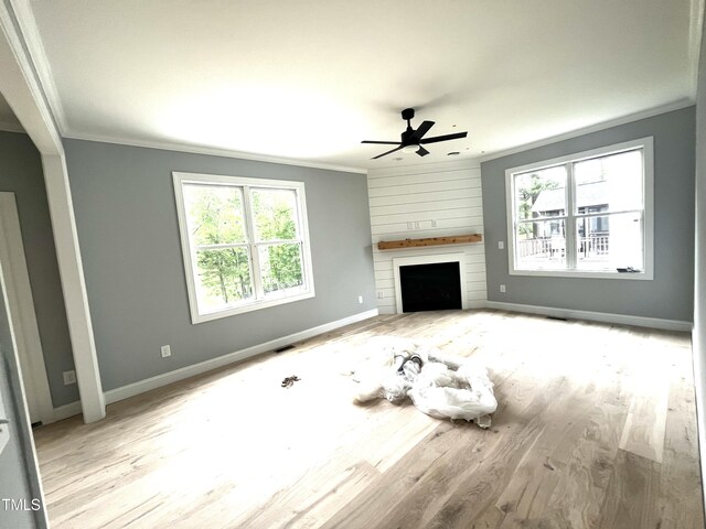 2651 Bowden Dr, Creedmoor, NC 27522 - unfurnished living room with crown molding, a ceiling fan, plenty of natural light, wood finished floors, and a large fireplace