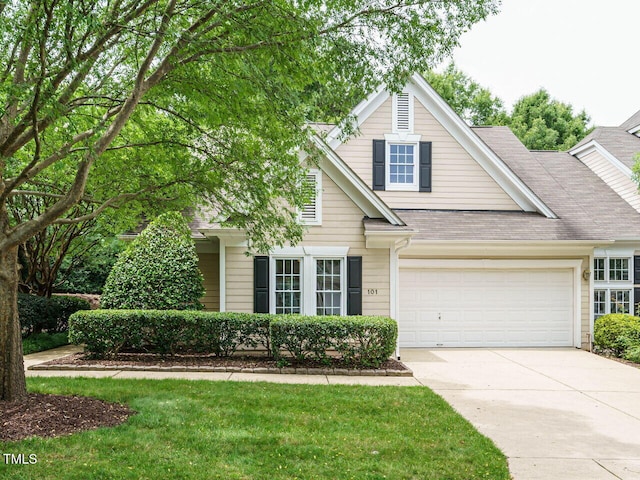 101 Lake Tillery Dr, Cary, NC 27519 - view of front of property with concrete driveway, a garage, roof with shingles, and a front yard
