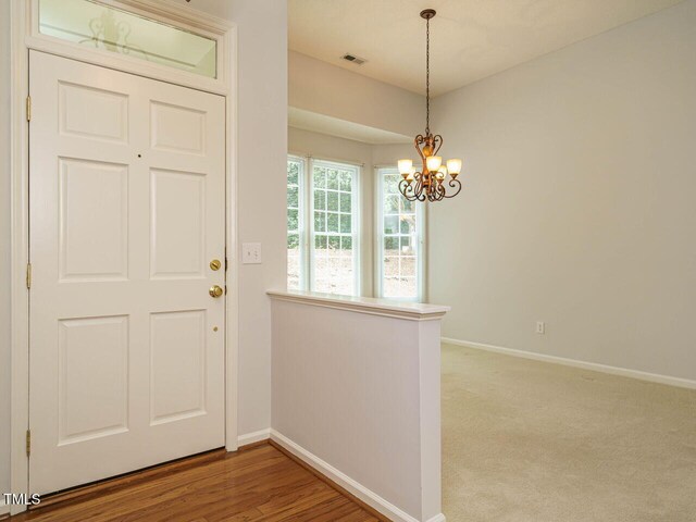 101 Lake Tillery Dr, Cary, NC 27519 - foyer featuring a chandelier and baseboards