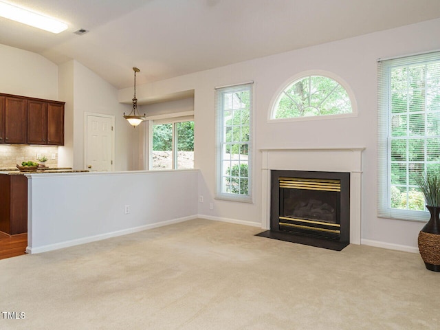101 Lake Tillery Dr, Cary, NC 27519 - unfurnished living room with light colored carpet, a fireplace with flush hearth, and vaulted ceiling