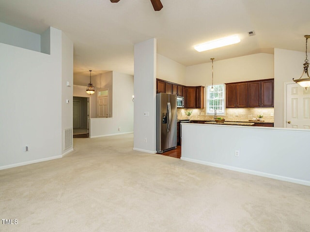 101 Lake Tillery Dr, Cary, NC 27519 - kitchen with stainless steel appliances, lofted ceiling, ceiling fan, light colored carpet, and decorative light fixtures