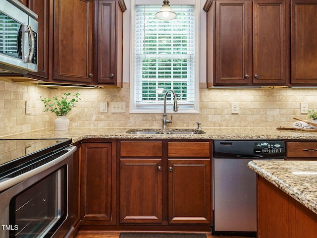 101 Lake Tillery Dr, Cary, NC 27519 - kitchen featuring appliances with stainless steel finishes, light stone counters, and tasteful backsplash
