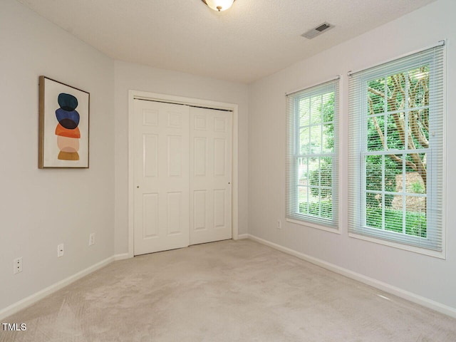 101 Lake Tillery Dr, Cary, NC 27519 - unfurnished bedroom featuring light carpet and a closet