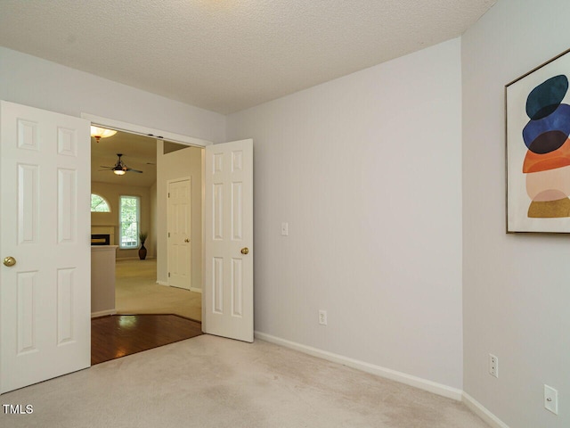 101 Lake Tillery Dr, Cary, NC 27519 - unfurnished room with carpet floors, a ceiling fan, and a fireplace