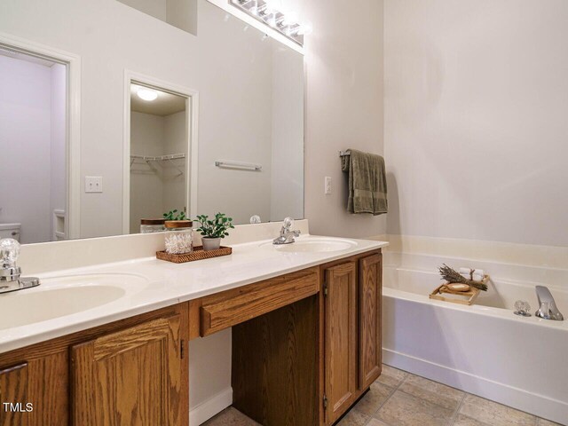 101 Lake Tillery Dr, Cary, NC 27519 - full bathroom featuring double vanity, a garden tub, and a walk in closet