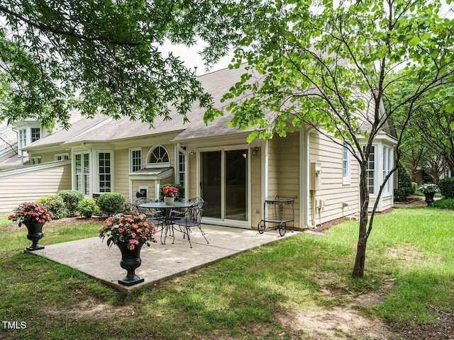 101 Lake Tillery Dr, Cary, NC 27519 - rear view of house with a patio, a lawn, and a shingled roof
