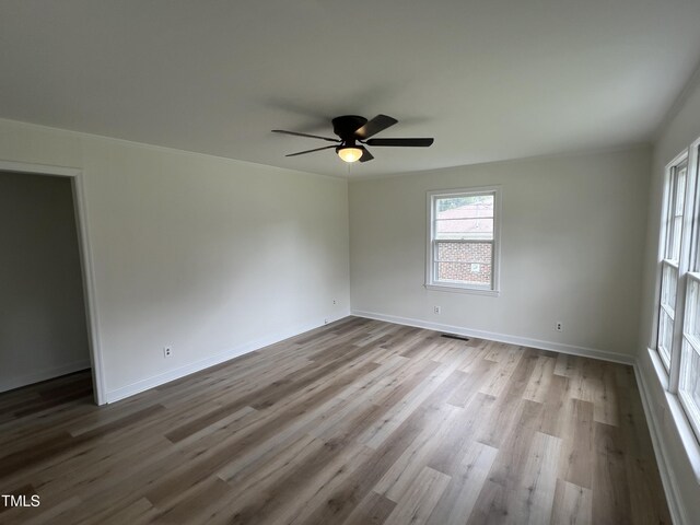 1851 S Clearview Dr, Henderson, NC 27536 - empty room featuring a ceiling fan, wood finished floors, and baseboards