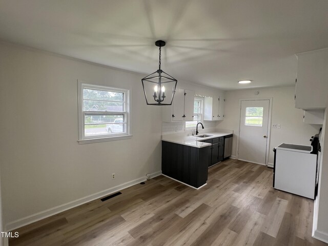 1851 S Clearview Dr, Henderson, NC 27536 - kitchen featuring range, a sink, light countertops, wood finished floors, and a chandelier