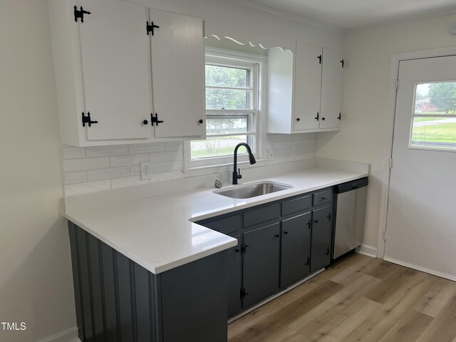 1851 S Clearview Dr, Henderson, NC 27536 - kitchen with a sink, stainless steel dishwasher, decorative backsplash, light wood-style floors, and crown molding