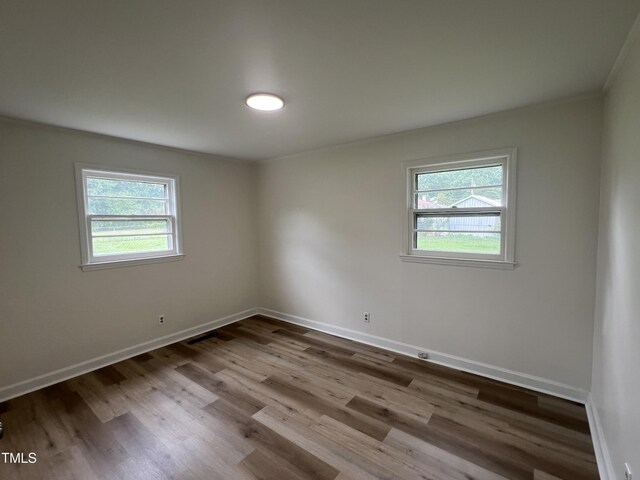 1851 S Clearview Dr, Henderson, NC 27536 - spare room with baseboards, wood finished floors, and ornamental molding