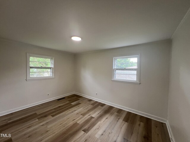1851 S Clearview Dr, Henderson, NC 27536 - empty room featuring plenty of natural light, baseboards, and wood finished floors