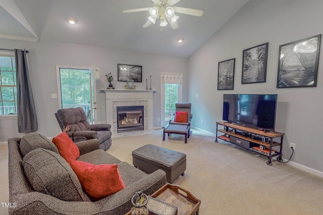734 Crystal Forest Dr, Semora, NC 27343 - living area with lofted ceiling, carpet floors, ceiling fan, plenty of natural light, and a tiled fireplace