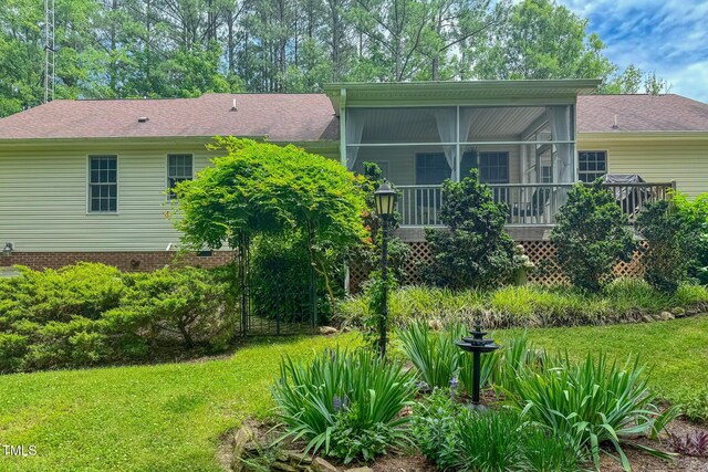 734 Crystal Forest Dr, Semora, NC 27343 - rear view of property featuring a lawn, a sunroom, and roof with shingles
